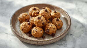 A plate of high protein peanut butter bites with chocolate chips.